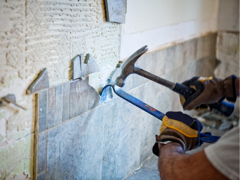 Jaetech removing tiles for a bathroom renovation.