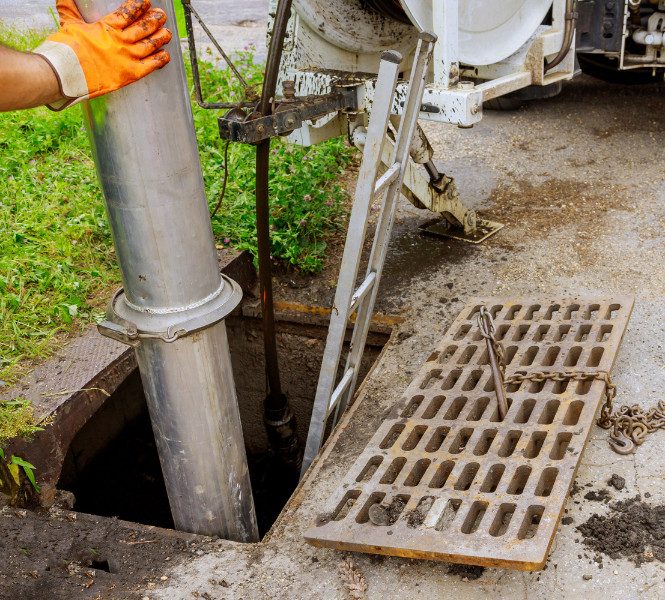 A licensed plumber carrying out a sanitary plumbing inspection
