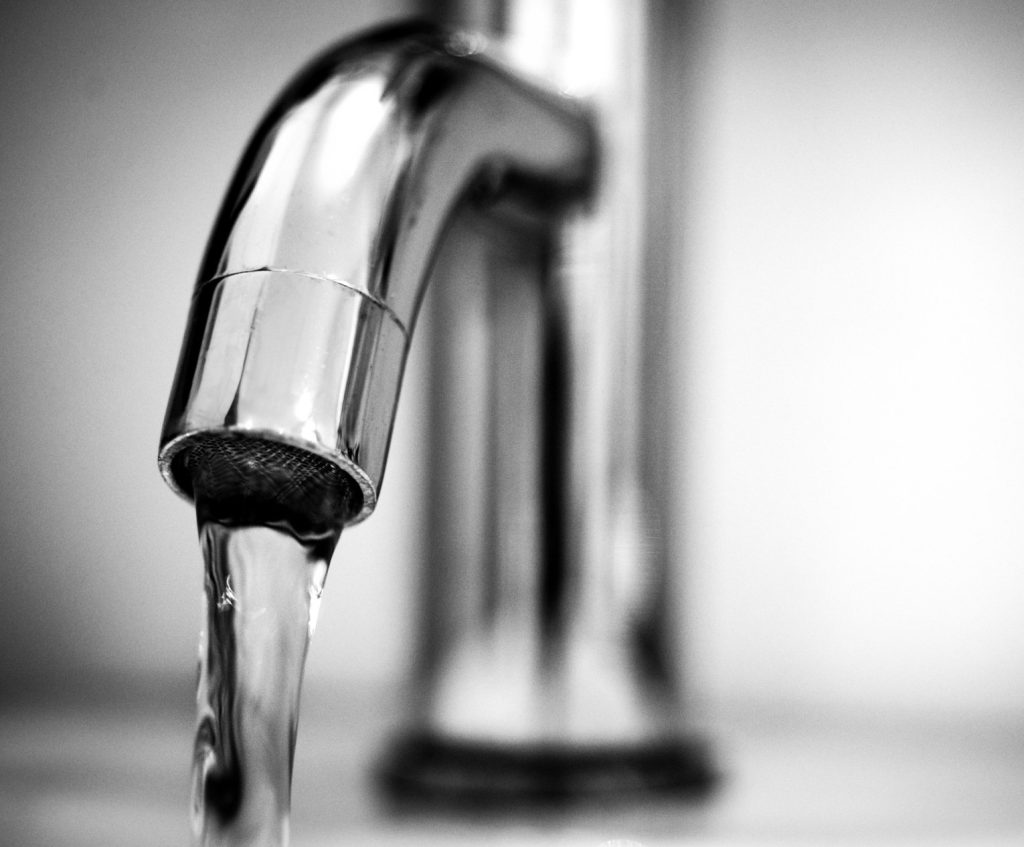 pexels-clickerhappy-615326 A plumber inspecting a backflow prevention device